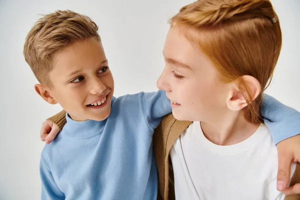 Cute preteen children in trendy casual attires hugging and smiling at each other, fashion concept — Stock Photo