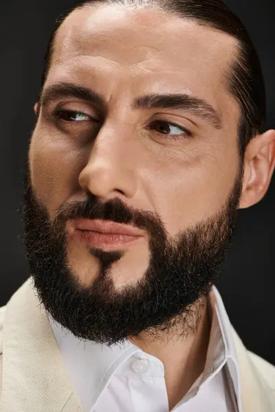 Close up portrait of bearded and confident arabic man in white shirt posing on black backdrop — Stock Photo