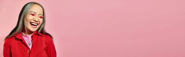 Valentines day banner, happy asian woman with heart eye makeup laughing on pink background — Stock Photo