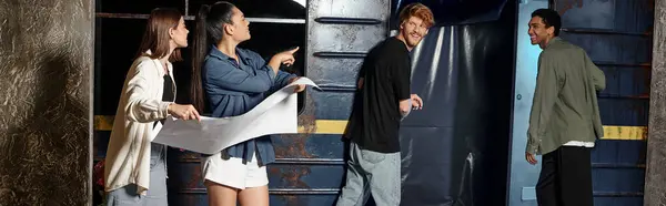 Happy girls with map pointing at subway wagon and looking at friends while solving quest, banner — Stock Photo