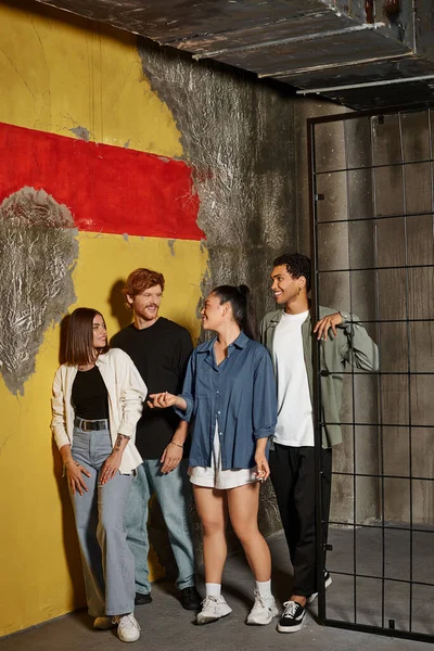 Happy interracial friends chatting near cage while solving quest in escape room, participation — Stock Photo