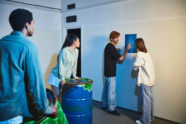 Redhead man showing clue to his interracial friends during quest in escape room, mystery solving — Stock Photo