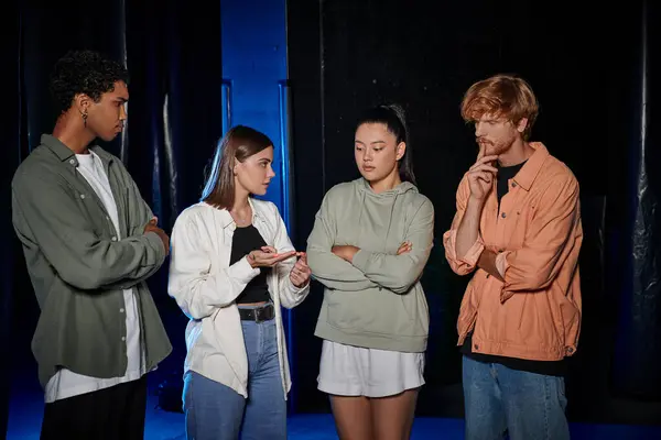 Group of four young multicultural friends discussing plan of escape during quest game, brainstorm — Stock Photo