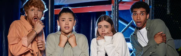 Banner of diverse and astonished young people looking at camera and discovering clue in escape room — Stock Photo