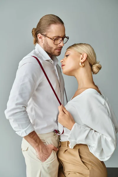 Good looking sexy couple with accessories in chic attires kissing lovingly in office, work affair — Stock Photo