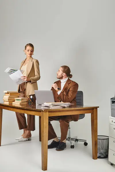 Attractive young couple posing together while at office and looking lovingly at each other — Stock Photo