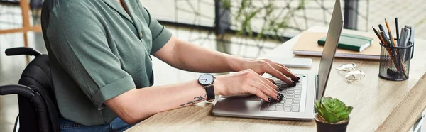 Cropped view of disabled businesswoman in casual attire sitting in wheelchair and working hard — Stock Photo