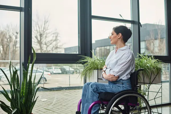 Красивая деловая женщина с ограниченной подвижностью сидит в инвалидном кресле и смотрит в сторону — стоковое фото