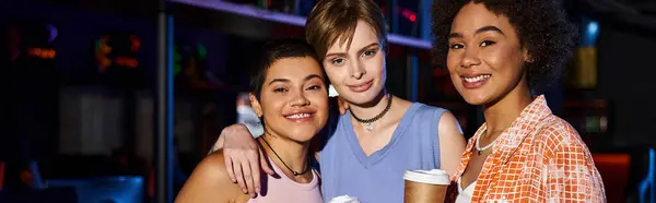 A group of happy interracial women enjoying a night out and looking at camera, banner — Stock Photo