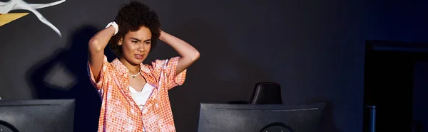 Frustrated african american woman with curly hair looking at computer and stressing out, banner — Stock Photo