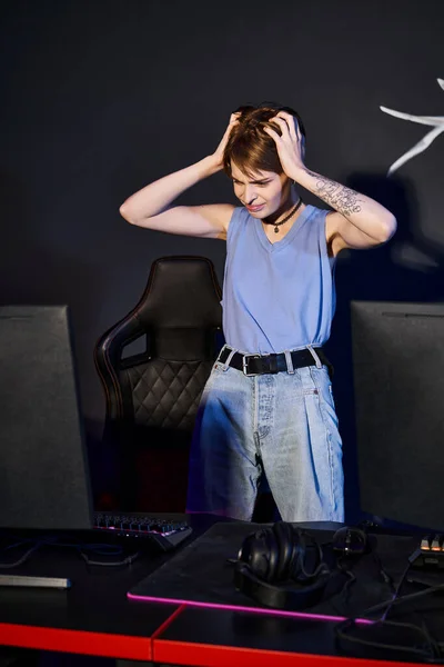 Frustrated woman with tattoo on hand looking at computer and stressing out, defeated player — Stock Photo