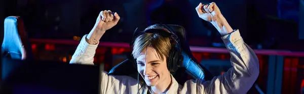 Cheerful female gamer rejoicing and looking at monitor after winning game, cybersport banner — Stock Photo