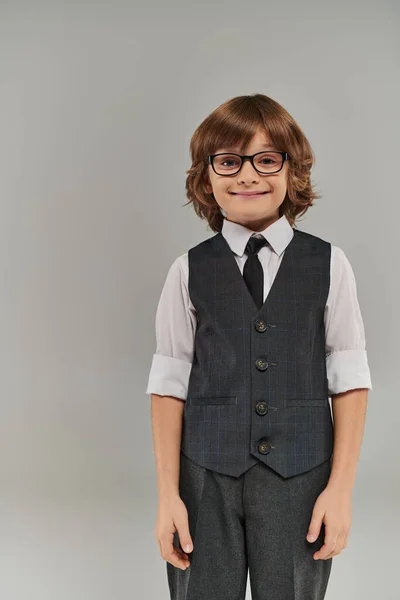 Stylish boy stands confidently, shirt buttoned up to collar and vest adding a touch to his look — Stock Photo