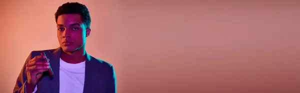 African american guy in blazer holding match with fire and cigar on pink background, banner — Stock Photo