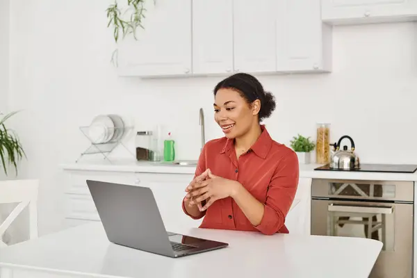 Remote work of cheerful female nutritionist providing online consultation from her kitchen — Stock Photo