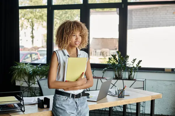 Ambitious curly african american entrepreneur in braces with documents in chic modern workspace — Stock Photo