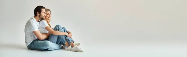 A man and a woman sit on the ground, embodying a scene of intimacy and love, banner — Stock Photo