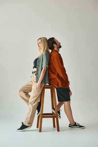 A sensual and romantic moment captured as a man and woman sit closely together on a stool — Stock Photo