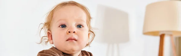 Adorable little boy looking away in crib in comfortable nursery room at home, horizontal banner — Stock Photo