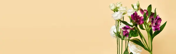 Object photo of fresh blooming lilies and eustoma flowers on pastel yellow background, banner — Stock Photo