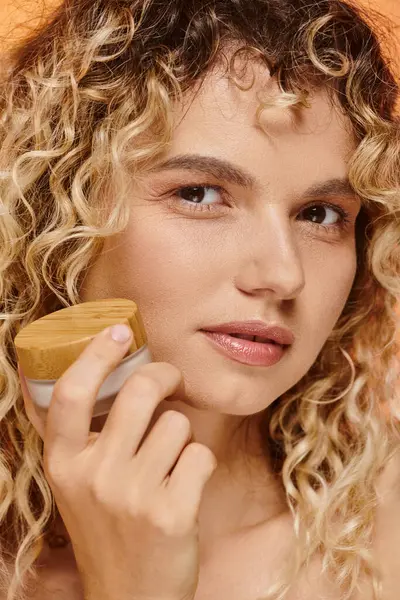 Close up retrato de mulher encaracolado com maquiagem natural e pele perfeita posando com creme facial — Fotografia de Stock