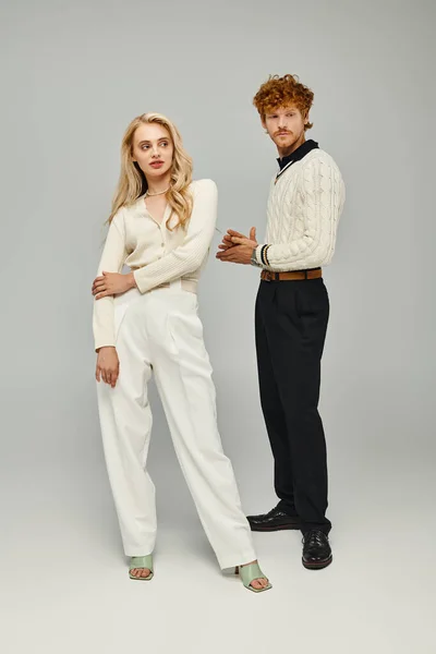 Full length of redhead man and blonde woman in trendy clothes on grey, classic old money style — Stock Photo