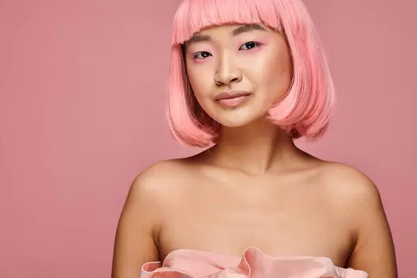 Beautiful asian girl in her 20s with pink hair and makeup against vibrant background — Stock Photo
