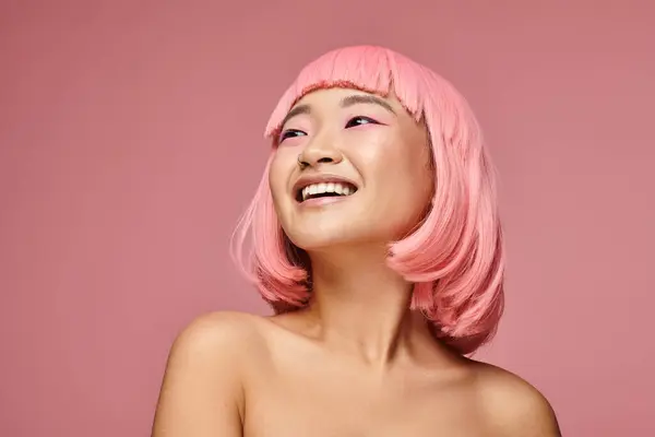 Portrait of charming asian girl with nose piercing laughing looking to up against vibrant background — Stock Photo