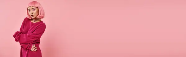 Horizontal shot of alluring asian woman in her 20s posing with hands against pink background — Stock Photo