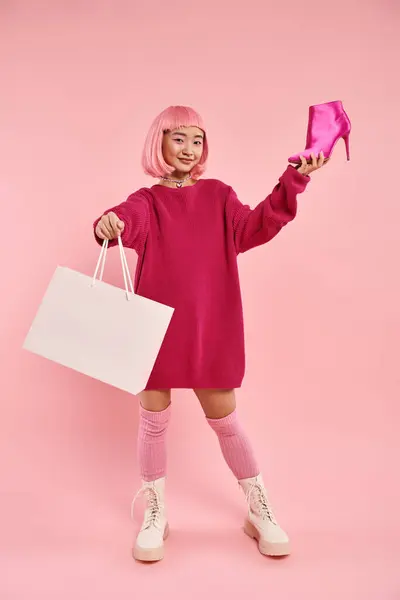 Charming asian woman in her 20s with happy smiling proud of her purchasing on pink background — Stock Photo