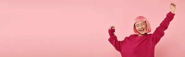 Horizontal shot of charming asian woman in 20s with pink hair very happy on vibrant background — Stock Photo