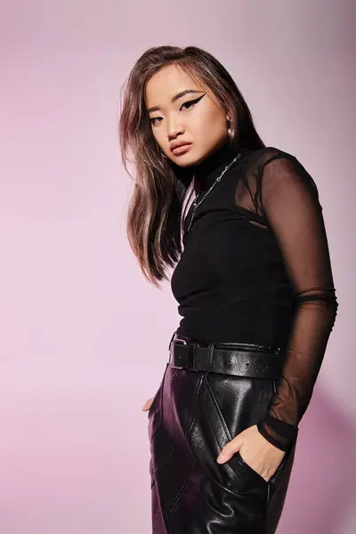 Pretty asian woman in her 20s with heavy makeup standing sideways and leaning head — Stock Photo