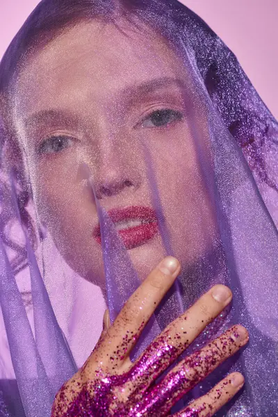 A young woman wearing a veil, raising her hands to her face in a studio setting, showcasing classic beauty in shades of grey. — Stock Photo