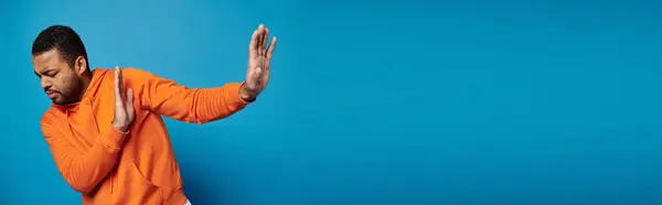 Banner of african american man in vibrant outfit with closed eyes refusing and hiding behind hands — Stock Photo