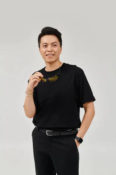 A fashionable young man in elegant attire standing confidently on white backdrop. — Stock Photo