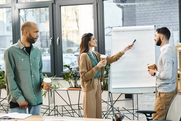 Diverse group standing in front of whiteboard, collaborating on project ideas in a modern office setting. — Stock Photo