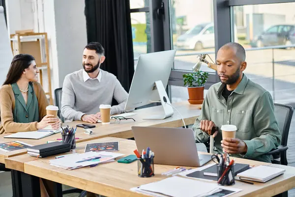 A diverse group of professionals brainstorming and collaborating on projects using laptops in a stylish office setting. — Stock Photo