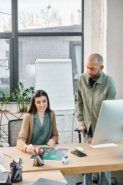 A man with myasthenia gravis and a woman immersed in their work at a desk in an office setting, embodying corporate collaboration. — Stock Photo