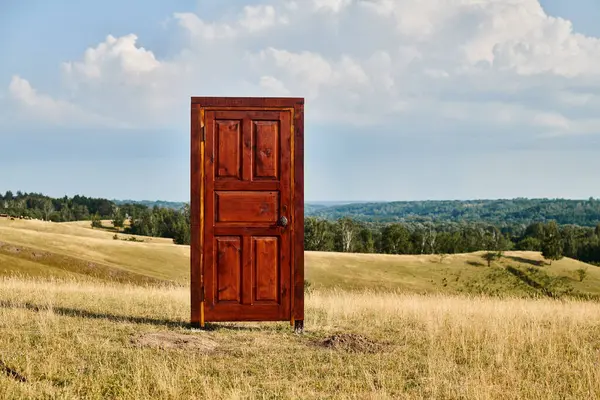 Object photo of red contemporary wooden closed doors in green spring field, scenic landscape — Stock Photo