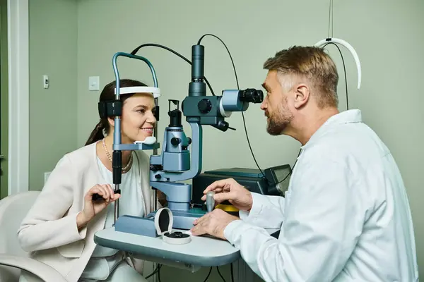 Handsome doctor checking his female patient vision. — Stock Photo