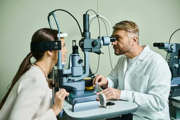 Appealing doctor checking his female patient vision. — Stock Photo