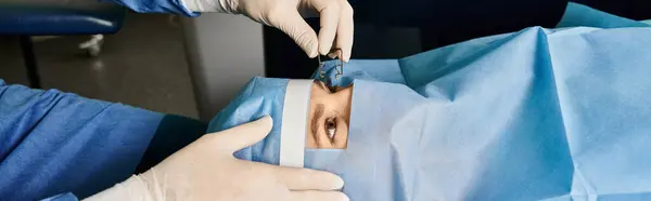 Hard working doctor performing laser vision correction on womans face. — Stock Photo