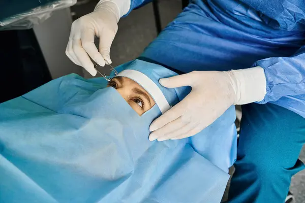 Dedicated doctor performing laser vision correction on womans face. — Stock Photo