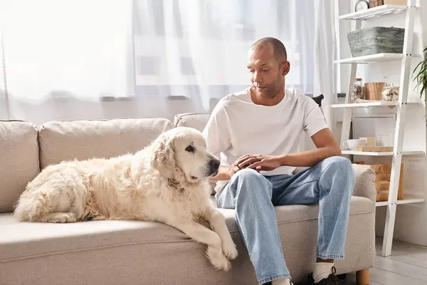 Myasthenia gravis patient and Labrador dog share a peaceful moment on the couch, embodying diversity and inclusion. — Stock Photo