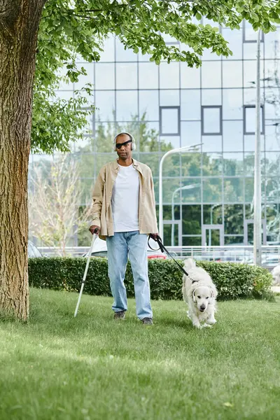 An African American man with myasthenia gravis syndrome walking his Labrador dog on a leash. — Stock Photo