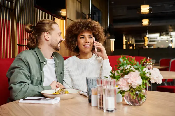 Une femme afro-américaine et un homme à une table de café moderne — Photo de stock