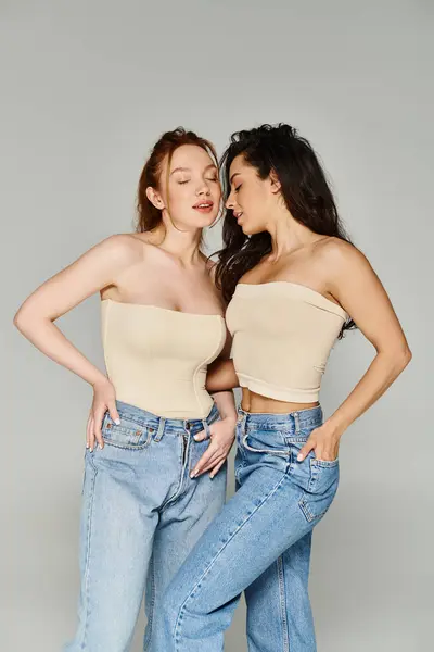 Two elegant women stand hand-on-hips, radiating joy and love. — Stock Photo
