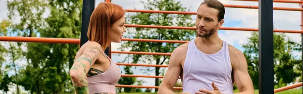 Un hombre y una mujer en ejercicio de ropa deportiva al aire libre, guiados por su programa personal, mostrando determinación y motivación. - foto de stock