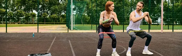 A man and a woman in sportswear, with a personal trainer, showcasing determination and motivation — Stock Photo