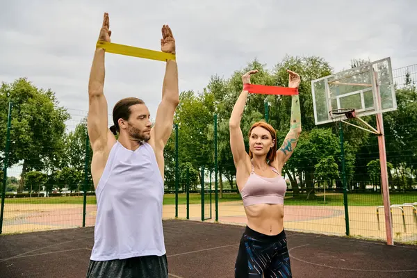 A man and woman in sportswear during resistance band training — Stock Photo